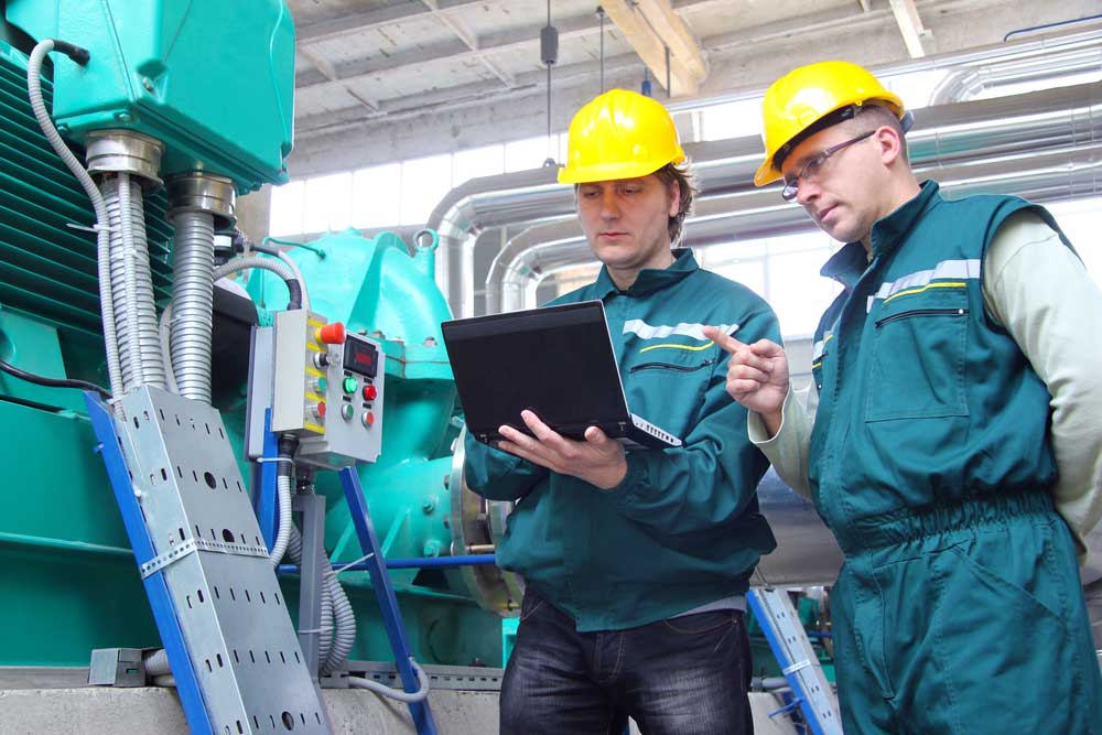 Image: industrial workers with notebook and teamwork