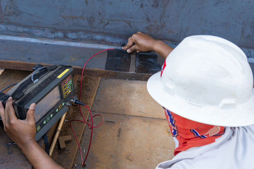 inspectors checking defects in welded steel with ultrasonic testing.